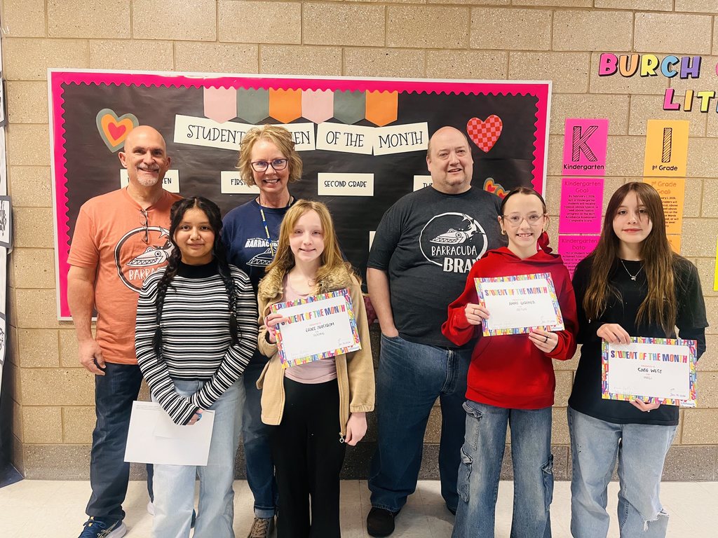 Photograph of student and citizen of the month award with teacher and students.