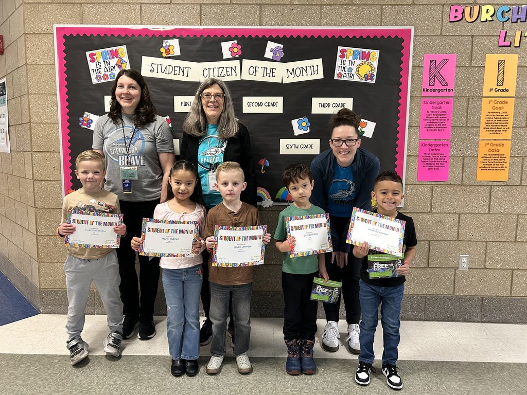 Photograph of student and citizen of the month award with teacher and students.