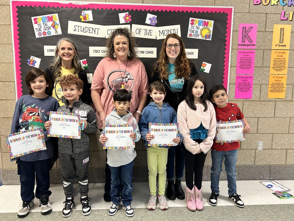 Photograph of student and citizen of the month award with teacher and students.