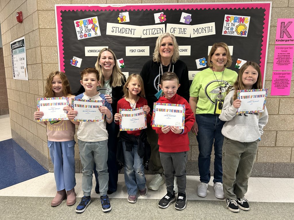 Photograph of student and citizen of the month award with teacher and students.
