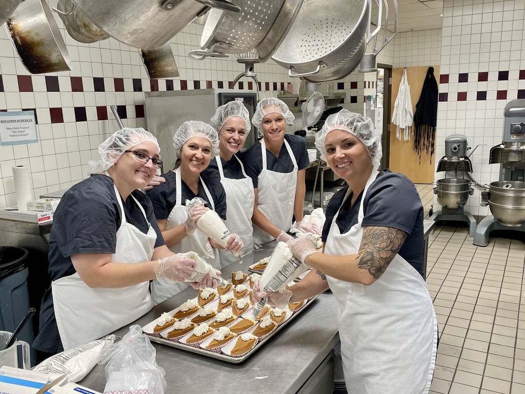 Lunch ladies posing with pie
