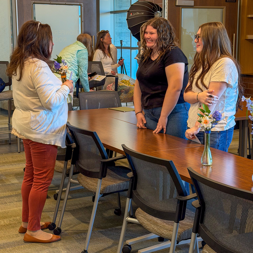 Students creating daffodil arrangements and delivering them