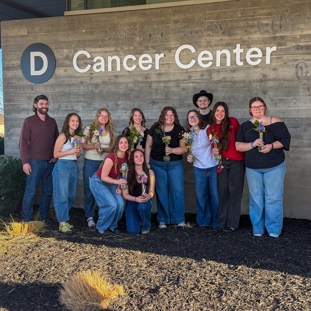 Students creating daffodil arrangements and delivering them