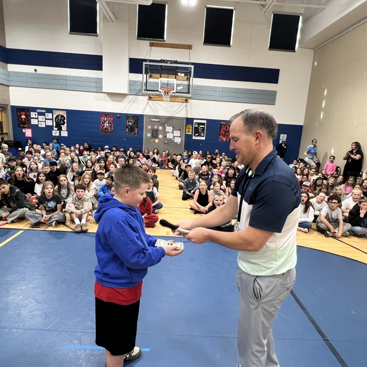 student receive dollar bills for participating in school-wide reading challenge