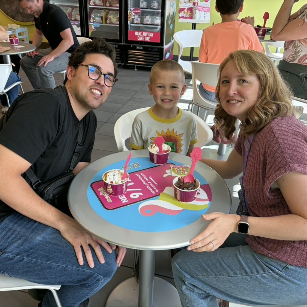 A boy and his parents eating Menchies 