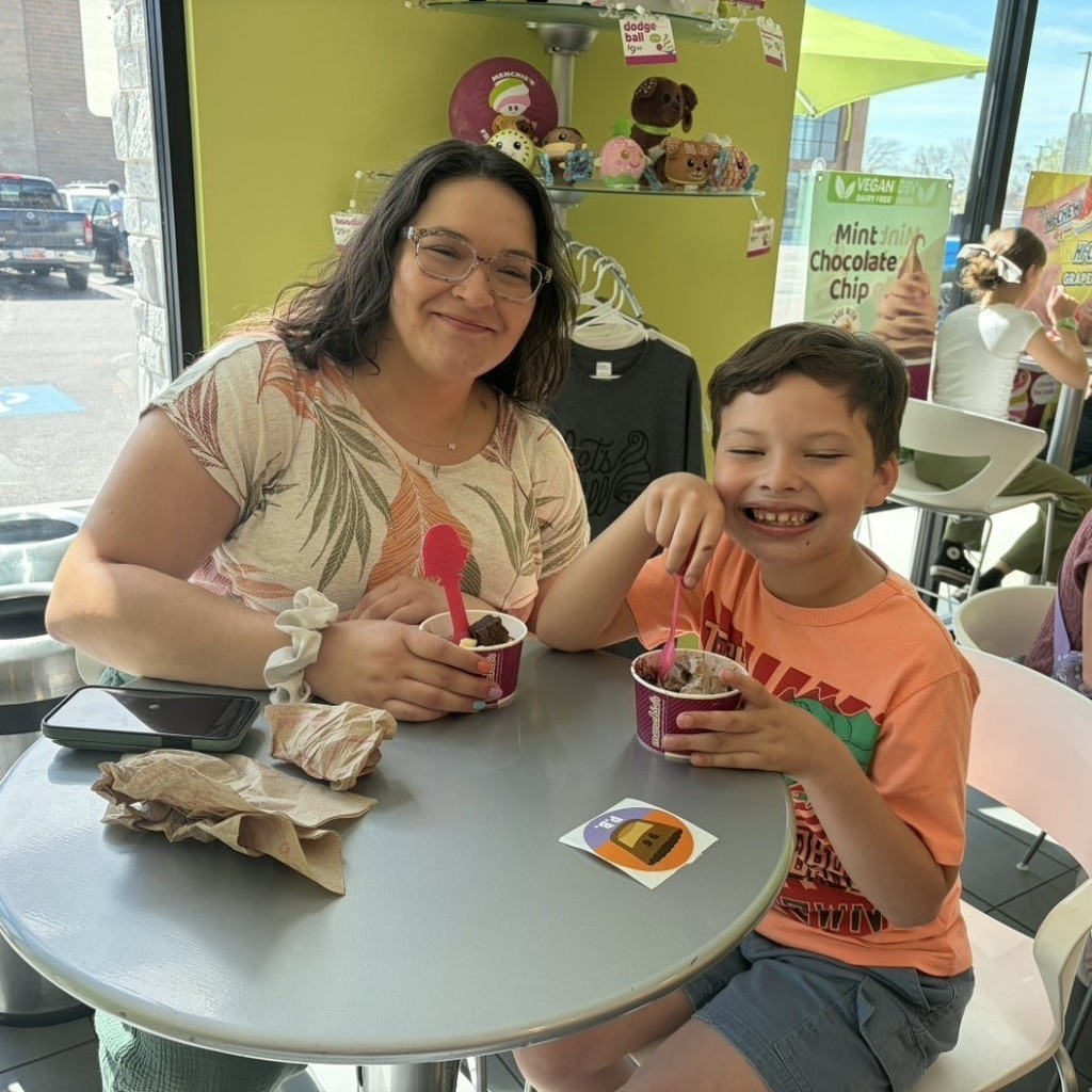 A boy and his parents eating Menchies 