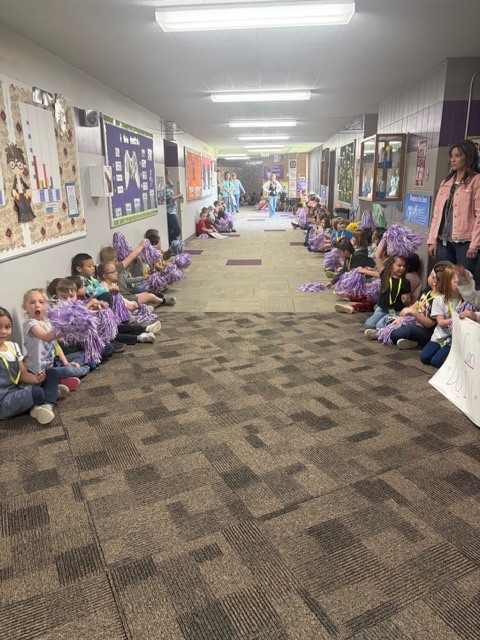 K-2 students waiting to cheer on the 3-6 graders