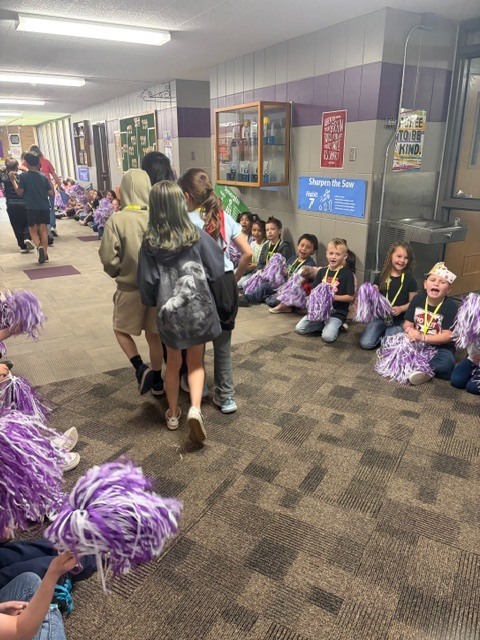 K-2 students cheering on the 3-6 students.