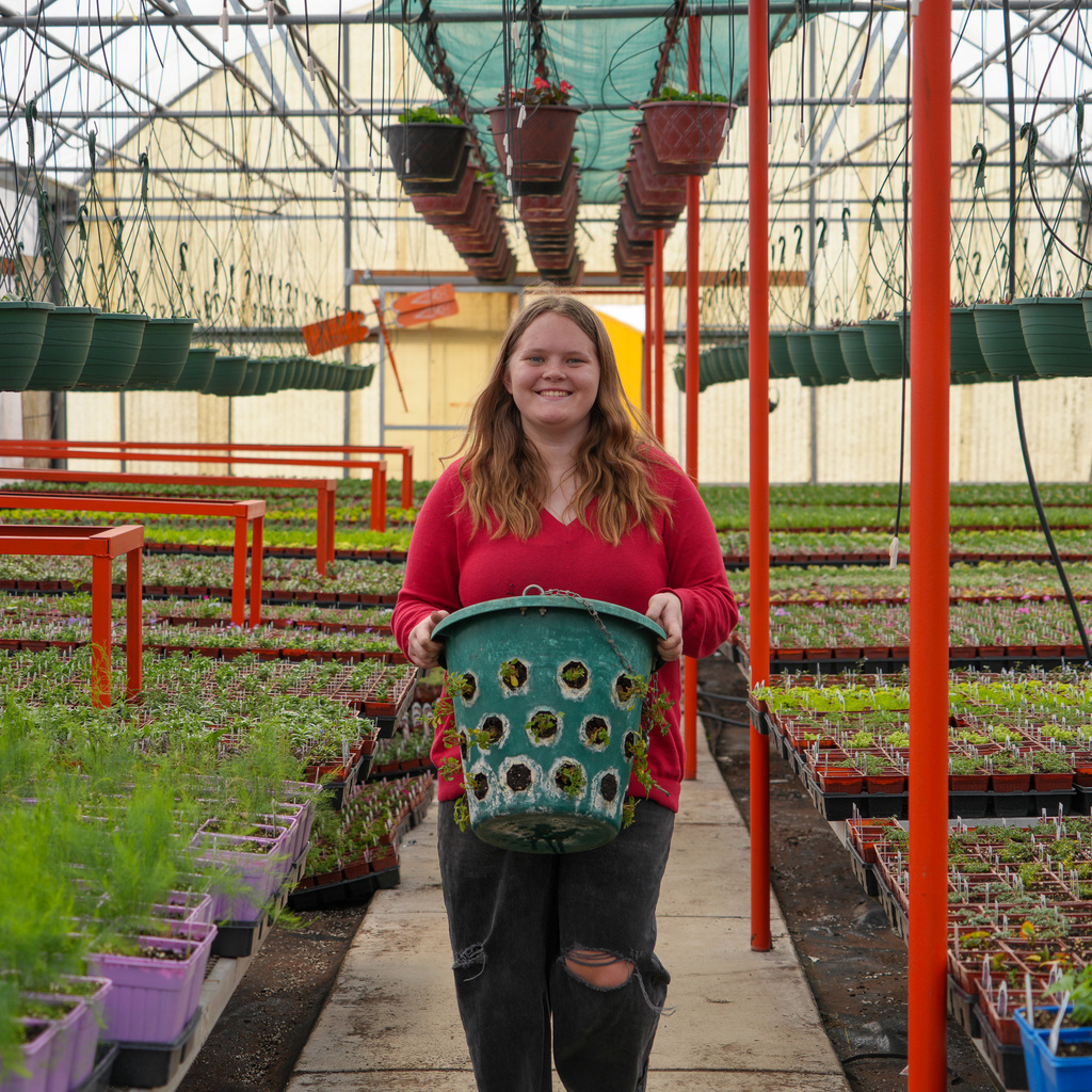 Student in greenhouse.