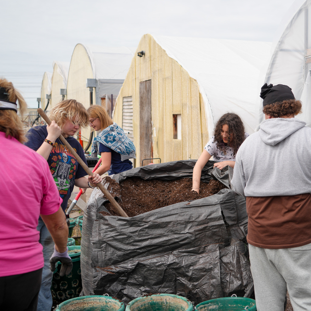 Students creating flower hanging baskets.