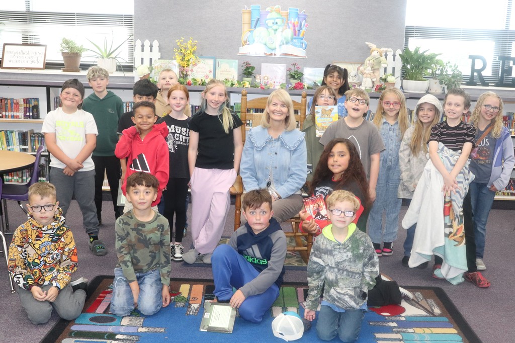 librarian surrounded by students