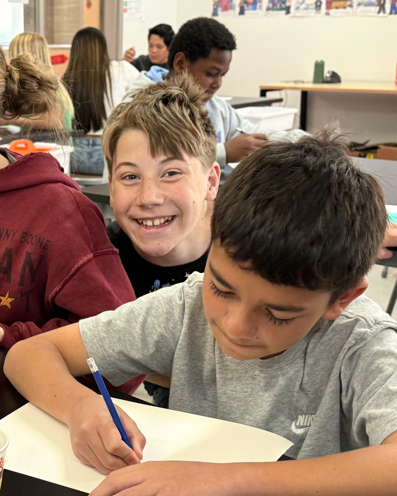 Students smiling while painting with watercolors in art class, showcasing original artwork and the impact of the Beverly Taylor Sorenson Foundation grant.