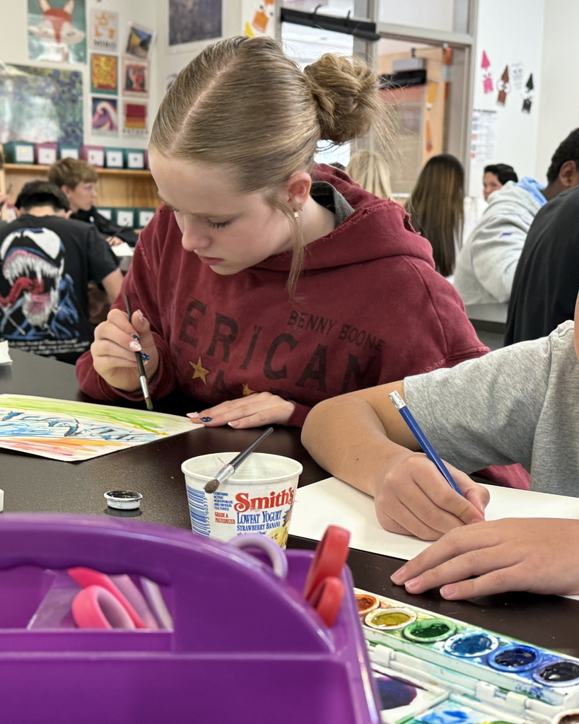 Students smiling while painting with watercolors in art class, showcasing original artwork and the impact of the Beverly Taylor Sorenson Foundation grant.