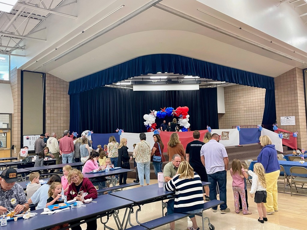 parents and family in the lunch room lined up waiting to get pictures taken