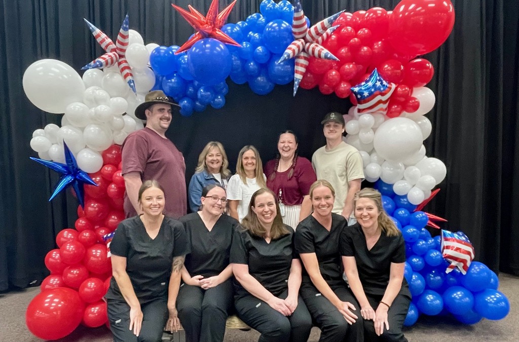 lunch staff, janitor staff, and administration staff smiling 