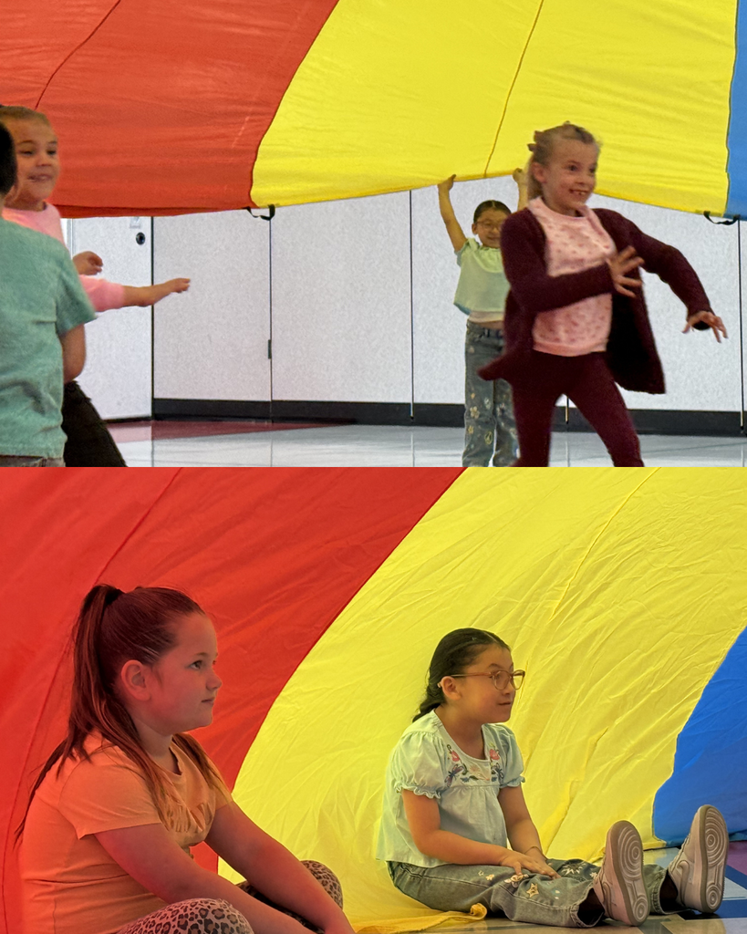 Students  exploriing a parachute activty during a PE lesson. 