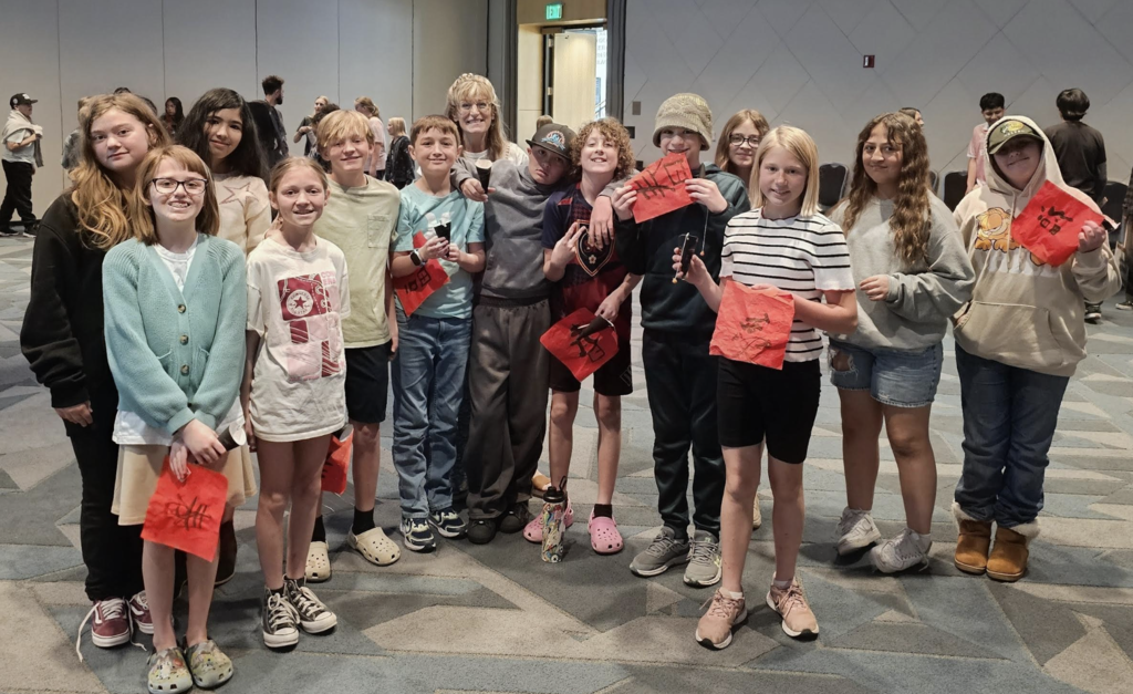 students together as a class smiling at a conference 