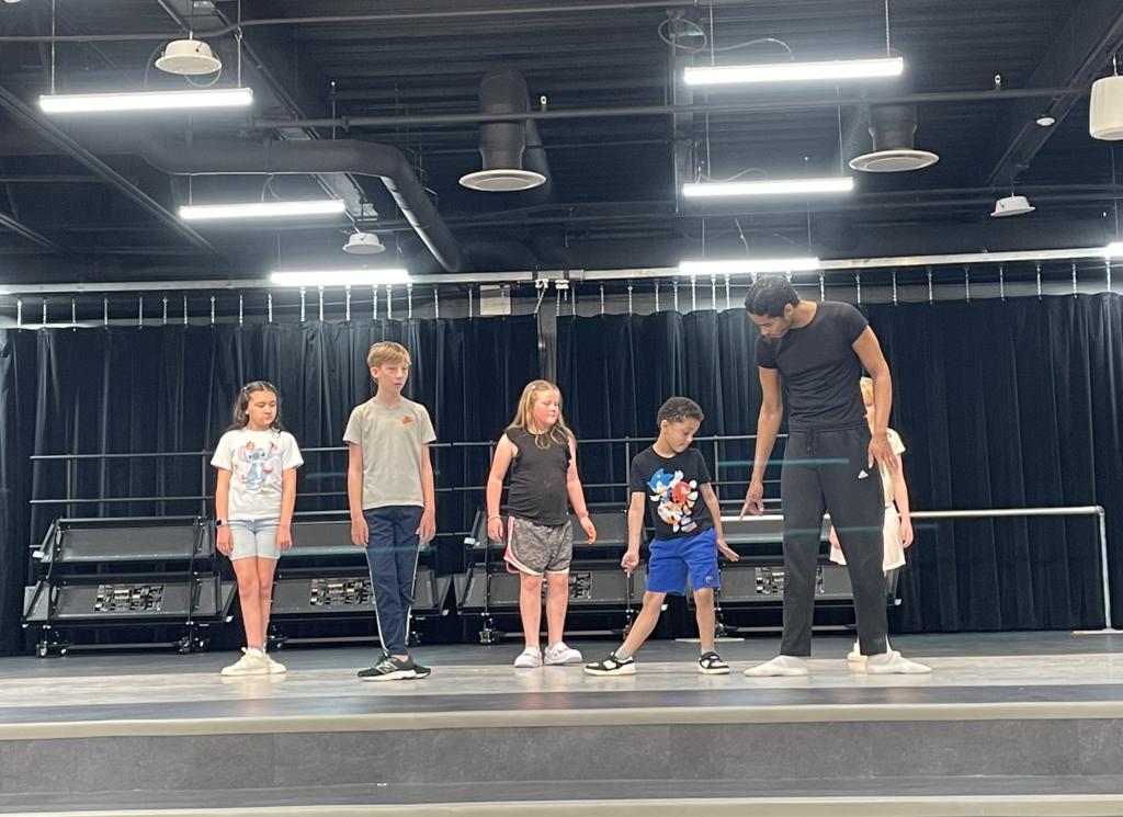students standing in a ballet pose 