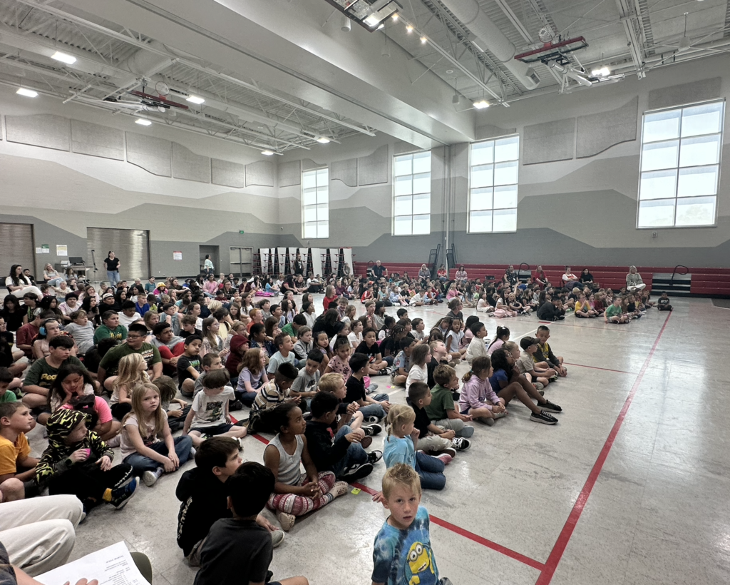 students sitting in the gymnasium for an assembly 