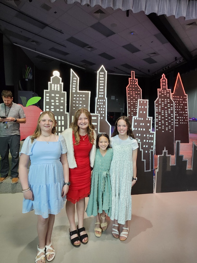 6th grade dance photos- girls in front of the city skyline