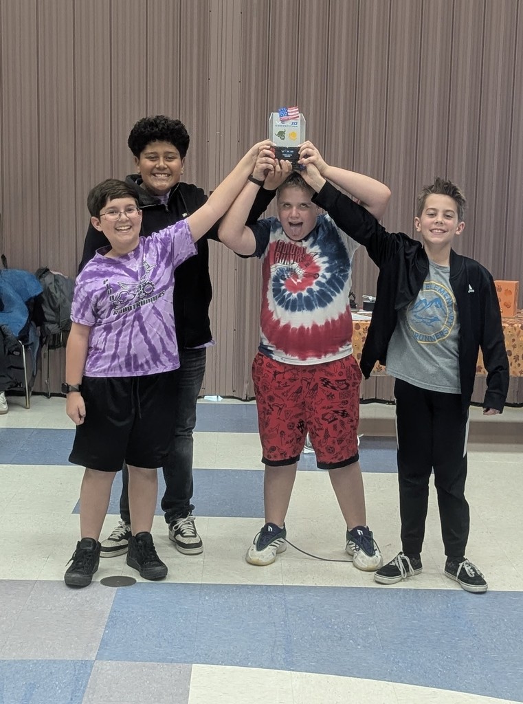 4 students posing with their award at a robotics competition