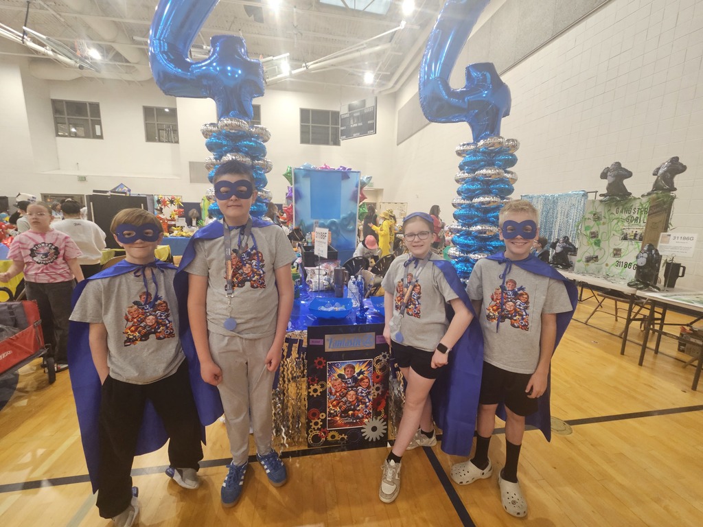 4 students posing with their costumes at the robotics state championships