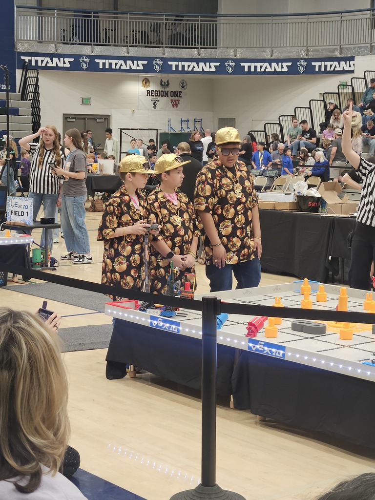 3 students competing in a robotics tournament