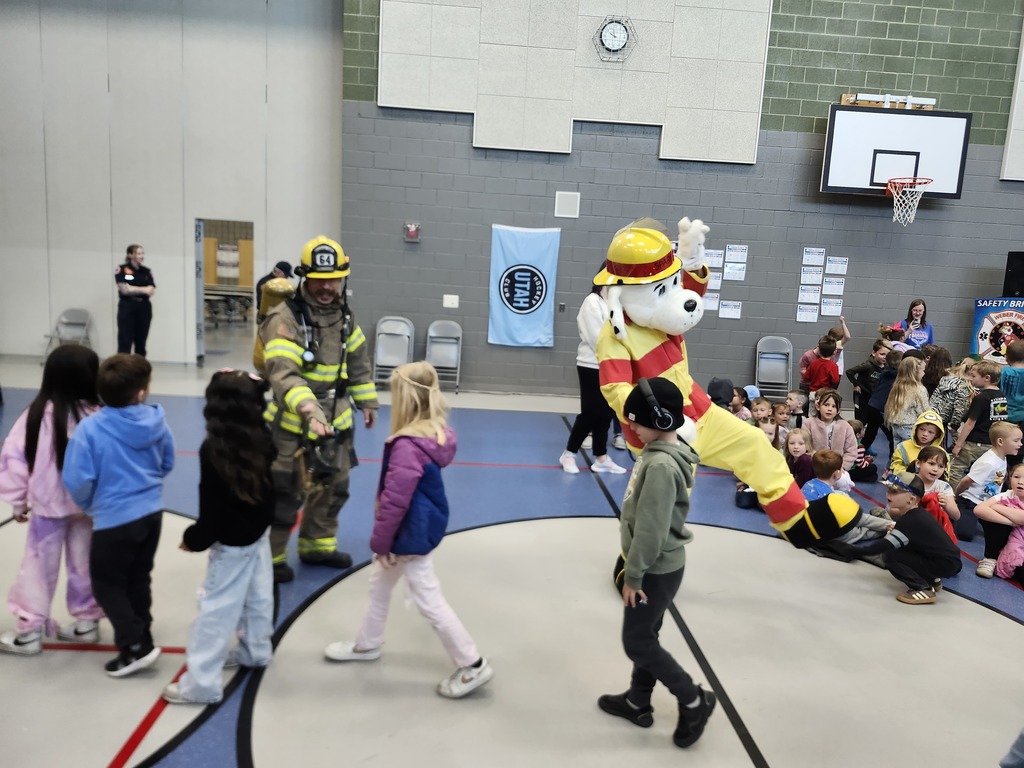 Weber Fire Presentation assembly. Kids saying goodbye to the firefighter and dancing with the Dalmatian