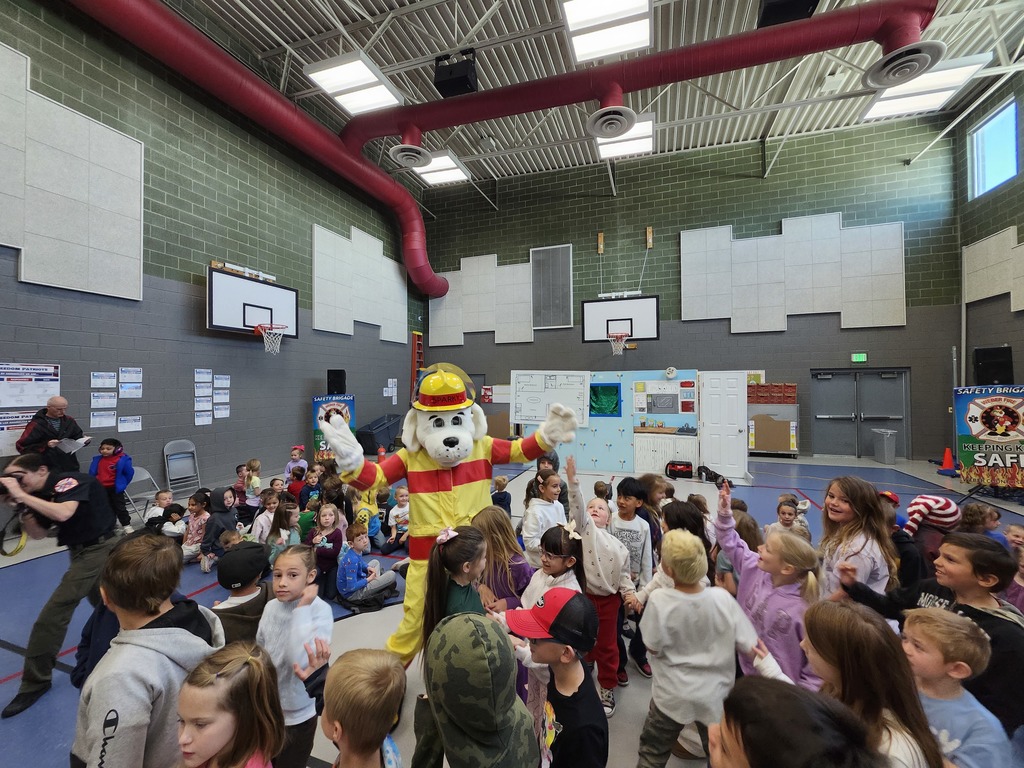 Weber Fire Presentation assembly.  Kids dancing with the dalmatian