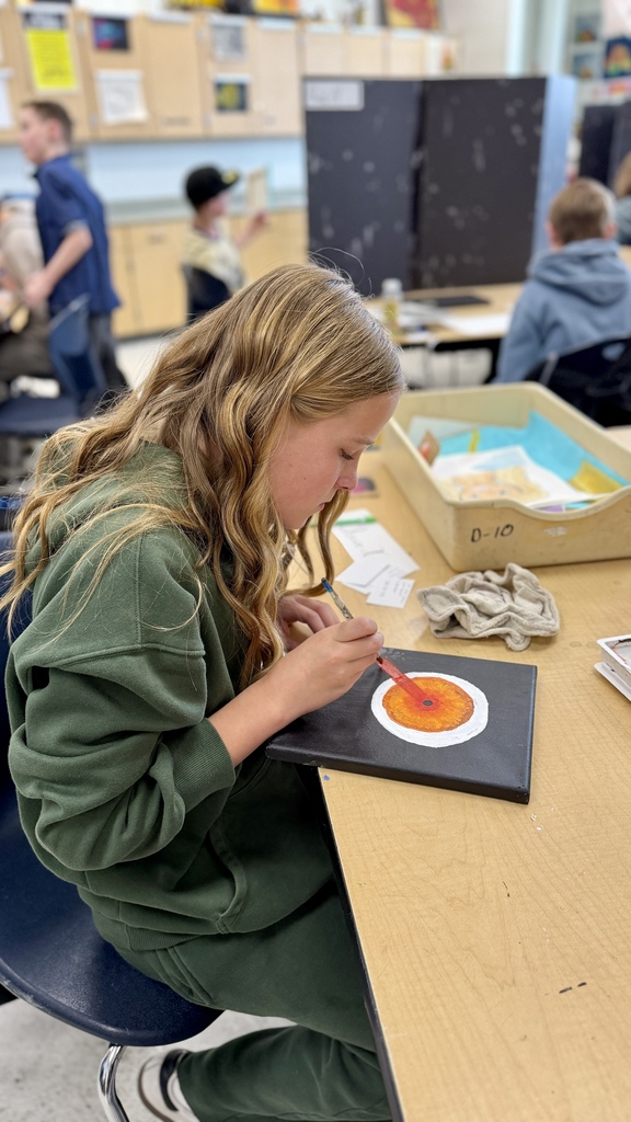 Kids prepping art show presentations.