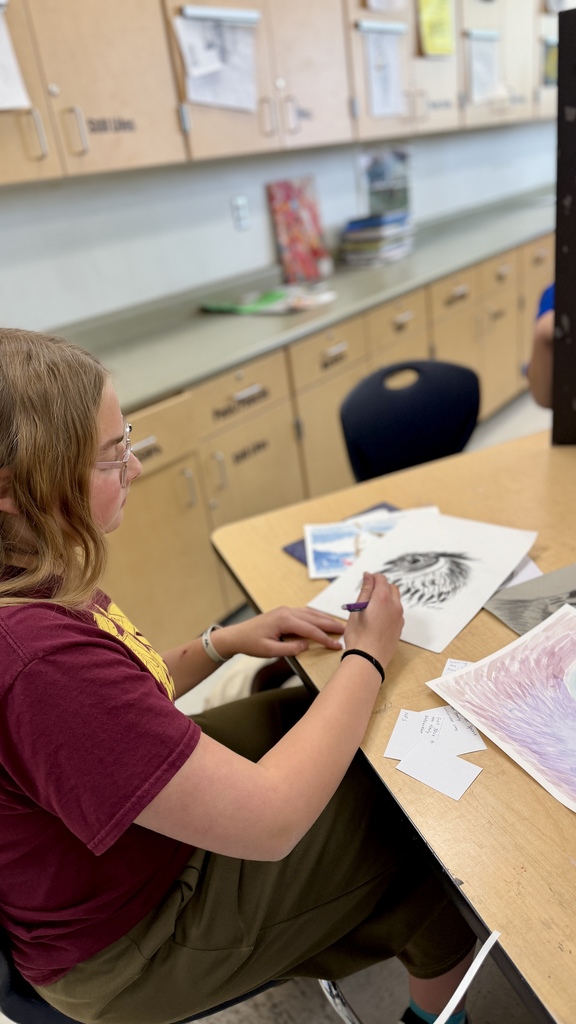 Kids prepping art show presentations.