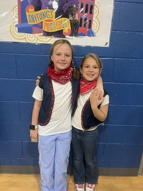 Students dressed as cowboys singing in a school choir.