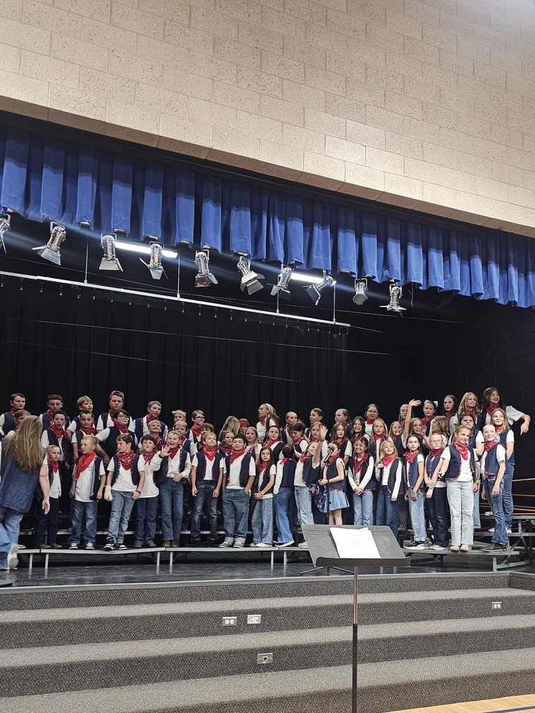 Students dressed as cowboys singing in a school choir.