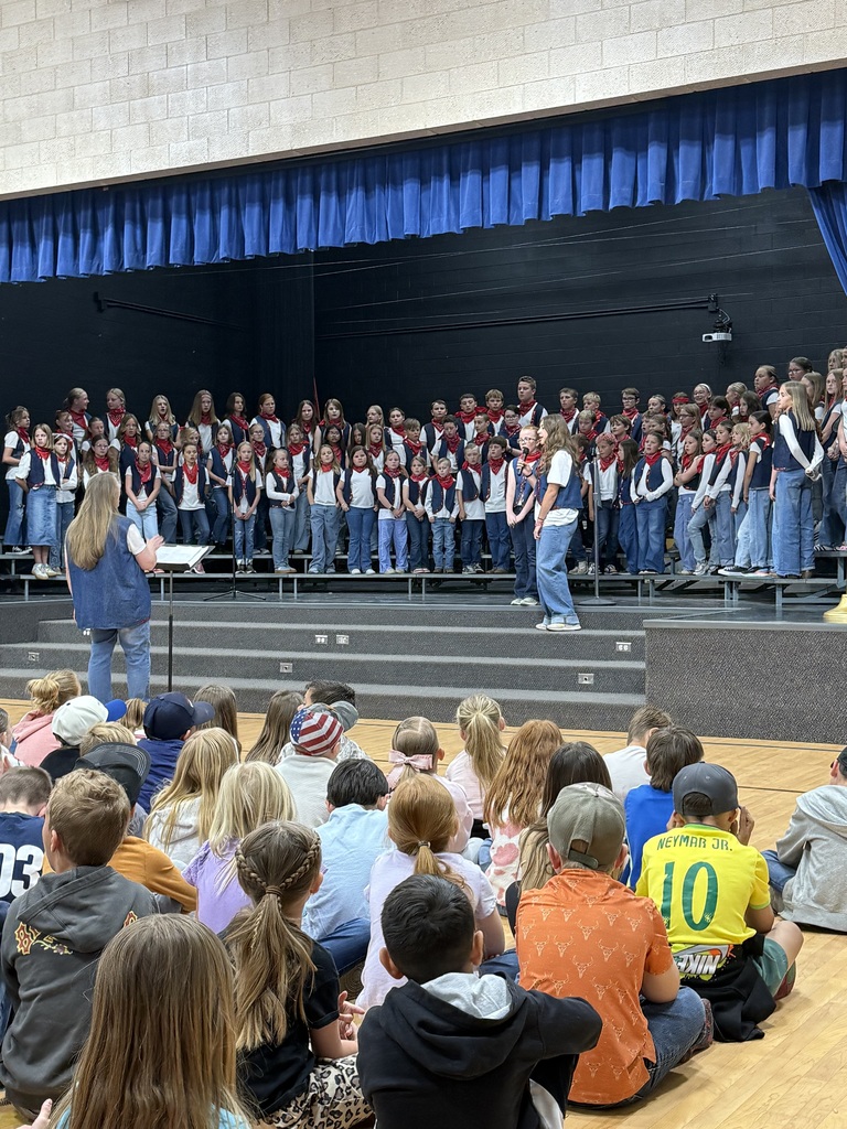 Students dressed as cowboys singing in a school choir.