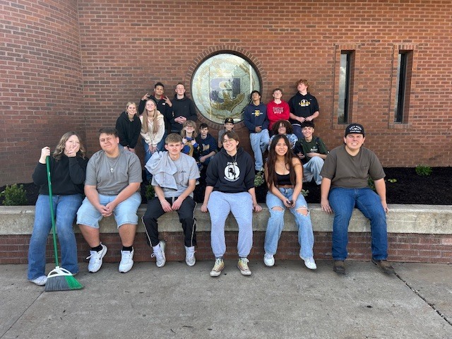 Students posing in front of the school.