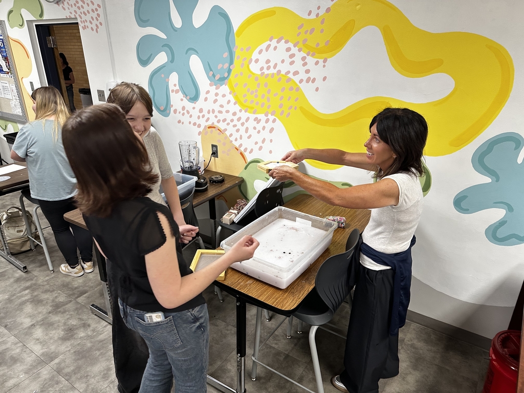 Ms. Fredrickson being taught by students.
