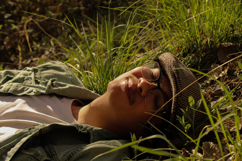 Student laying in grass