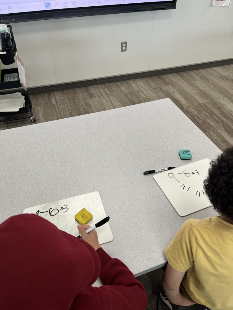 two students solving subtraction problems