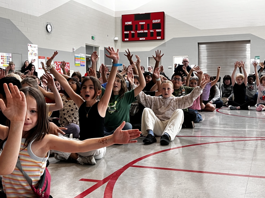 students all excitedly participating in the magician assembly