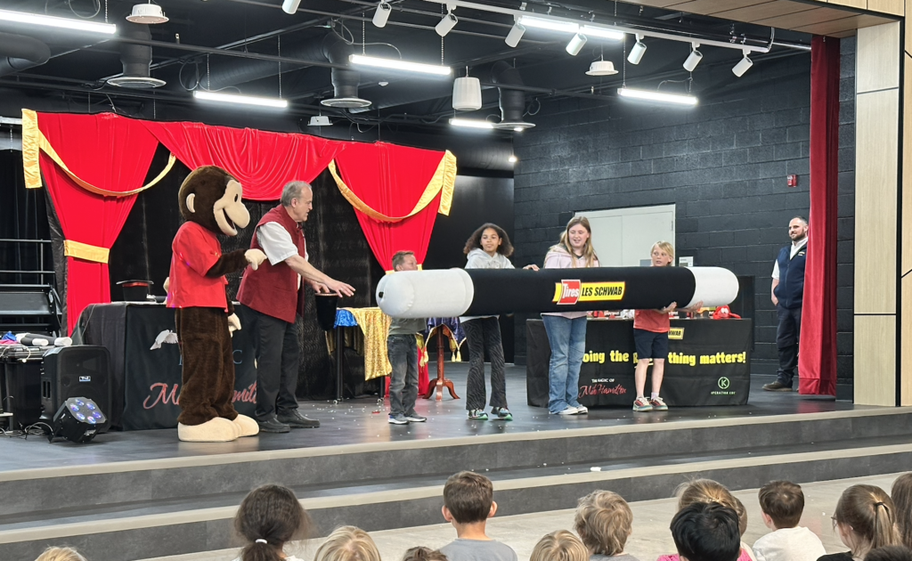 students holding a HUGE magic wand 