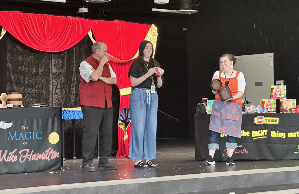 two teachers on stage with the magicain