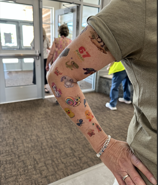 a teacher's arm all covered in tattoos