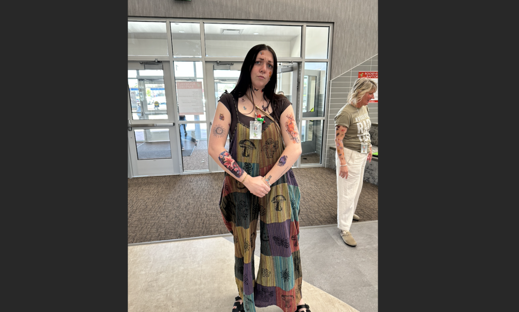 a teachers posing and showing off all of their tattoos