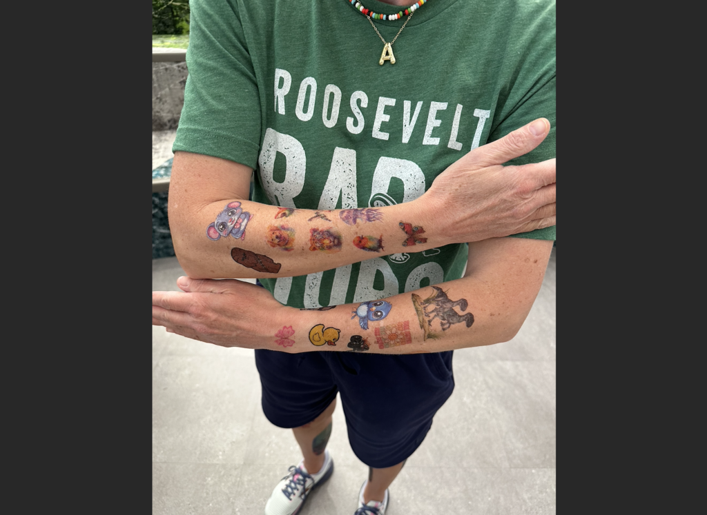 a teacher's arms showing off all  their tattoos