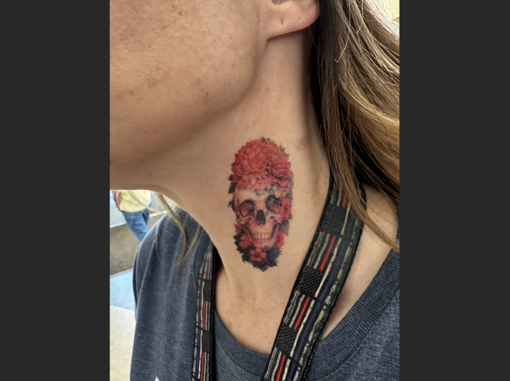 a teacher's neck with their tattoos