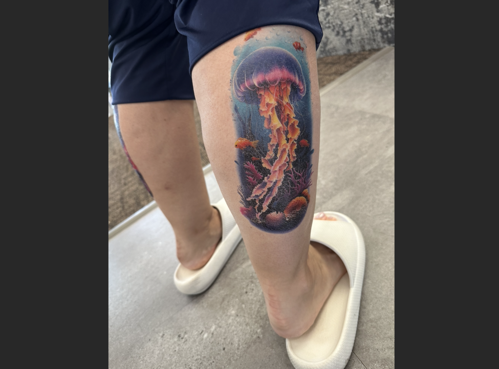 a teachers calf with their tattoos 