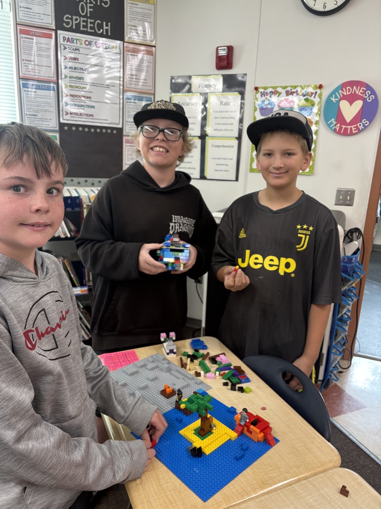 students smiling with lego