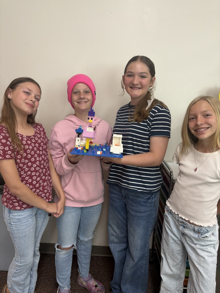 students smiling with lego
