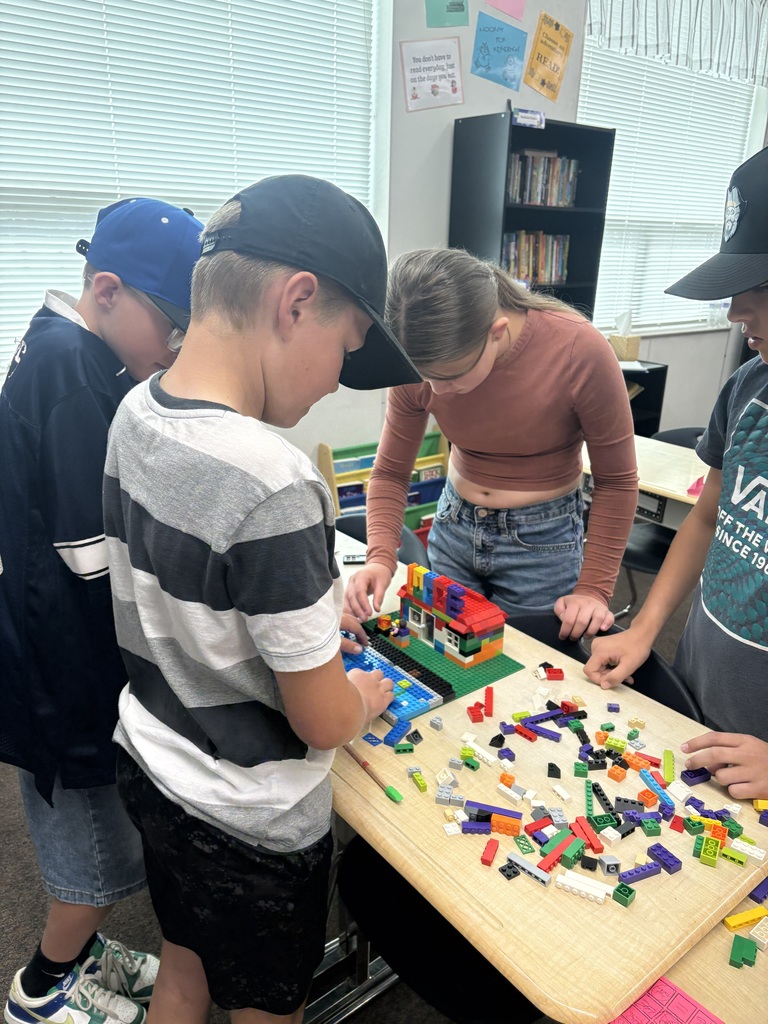 students smiling with lego