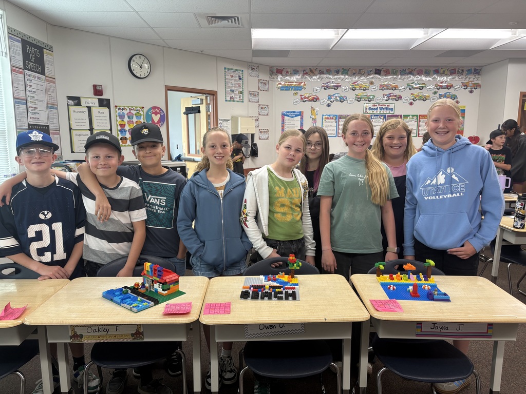 students smiling with lego